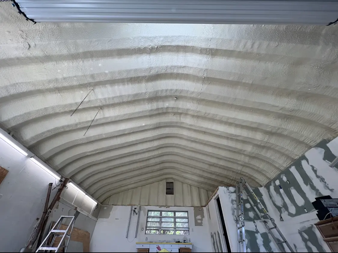 Spray polyurethane foam applied to the underside of a metal roof deck in Spirit Lake